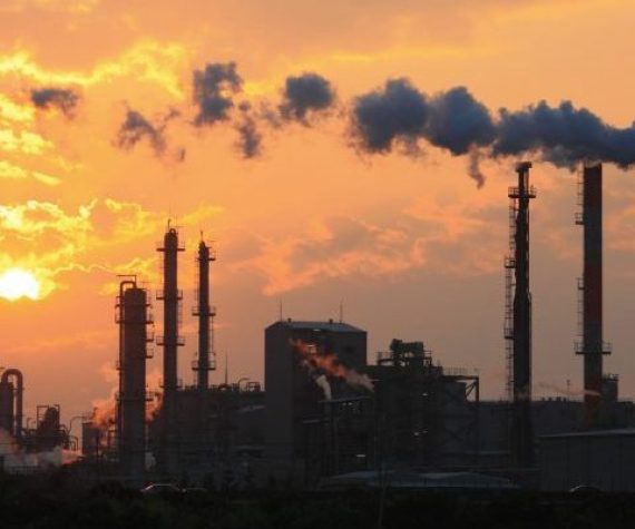Air pollution smoke from pipes and factory with sunset background