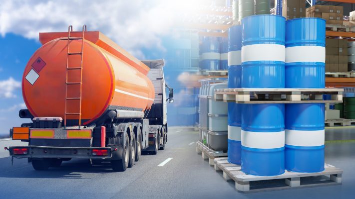 Fuel,Tanker,Truck,Transporting,Flammable,Liquid,Passes,By,Pallets,Of