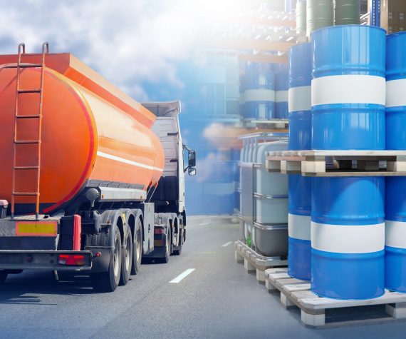 Fuel,Tanker,Truck,Transporting,Flammable,Liquid,Passes,By,Pallets,Of